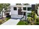 View of modern two-story home featuring a three-car garage and manicured landscaping at 4816 W San Jose St, Tampa, FL 33629