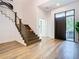Home entryway showcasing modern staircase, hardwood floors, and a modern front door at 4816 W San Jose St, Tampa, FL 33629