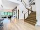 Bright entryway featuring a wooden staircase, hardwood floors, and an open floor plan at 4816 W San Jose St, Tampa, FL 33629