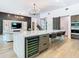Bright kitchen with center island, stainless steel appliances, and a wine fridge, creating a modern and functional space at 4816 W San Jose St, Tampa, FL 33629