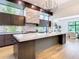 Open kitchen with marble island, modern lighting, high-end appliances, and a sleek chef's range at 4816 W San Jose St, Tampa, FL 33629
