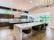 Kitchen features a marble island with bar seating, high-end appliances, and modern lighting at 4816 W San Jose St, Tampa, FL 33629