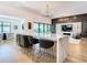 Open kitchen with marble island with bar seating, high-end appliances, modern lighting, and an eat-in kitchen at 4816 W San Jose St, Tampa, FL 33629