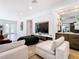 Bright living room with a large sectional sofa, wood floors, and custom bar at 4816 W San Jose St, Tampa, FL 33629
