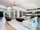 Open-concept living room featuring modern lighting, wine cellar, and hardwood flooring at 4816 W San Jose St, Tampa, FL 33629