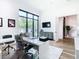 Well-lit home office with a sleek white desk, a comfortable chair, and a large window at 4816 W San Jose St, Tampa, FL 33629