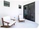 Outdoor patio includes two modern chairs and access to the indoors via sliding glass doors at 4816 W San Jose St, Tampa, FL 33629