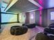 Home theater with plush seating, immersive screen, and custom lighting creating an unparalleled entertainment experience at 4816 W San Jose St, Tampa, FL 33629