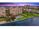 Breathtaking aerial shot of luxury condos with a pool and waterfront views, ideal for upscale living at 4981 Bacopa S Ln # 103, St Petersburg, FL 33715