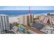 High-rise building overlooks a beach with a private pool and a sunny Florida sky at 5000 Gulf Blvd # 304, St Pete Beach, FL 33706