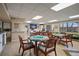 The bright community room features tables, chairs, a TV, and a kitchenette for resident gatherings at 5000 Gulf Blvd # 304, St Pete Beach, FL 33706