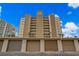 Building exterior featuring attached garages, lush landscaping and convenient parking at 5000 Gulf Blvd # 304, St Pete Beach, FL 33706