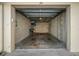 Open garage shows bare concrete walls and floor with some storage shelving at the far end at 5000 Gulf Blvd # 304, St Pete Beach, FL 33706