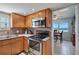 Efficient kitchen space with stainless steel appliances and warm wood cabinets at 5000 Gulf Blvd # 304, St Pete Beach, FL 33706