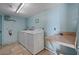 Spacious laundry room with a utility sink, storage, and a tiled floor at 5000 Gulf Blvd # 304, St Pete Beach, FL 33706