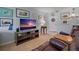 Cozy living area with a television and collection of artwork displayed on the wall at 5000 Gulf Blvd # 304, St Pete Beach, FL 33706