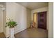 Entryway featuring tiled floors, warm lighting and a decorative plant at 5000 Gulf Blvd # 304, St Pete Beach, FL 33706