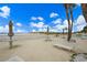 An inviting outdoor patio near the beach is furnished with tables, umbrellas, and lounge chairs at 5000 Gulf Blvd # 304, St Pete Beach, FL 33706
