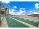 Outdoor shuffleboard courts offer beachfront recreation with a building and blue skies in the background at 5000 Gulf Blvd # 304, St Pete Beach, FL 33706