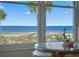 Lovely ocean view from a window, overlooking the beach and palm trees at 5000 Gulf Blvd # 304, St Pete Beach, FL 33706
