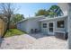 Backyard view featuring gravel, stone pavers, new privacy fence, and a cozy seating area at 5050 Emerson S Ave, St Petersburg, FL 33707