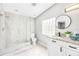 Bathroom featuring glass-enclosed shower, granite countertop vanity, and block glass window for natural light at 5050 Emerson S Ave, St Petersburg, FL 33707