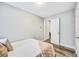 Cozy bedroom with neutral walls, wood-look floors, closet access and ceiling fan at 5050 Emerson S Ave, St Petersburg, FL 33707