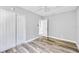 Bright bedroom featuring wood-look floors, neutral walls, ceiling fan, and closet at 5050 Emerson S Ave, St Petersburg, FL 33707