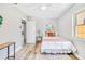 Bright bedroom with wood-look floors, neutral walls, ceiling fan, and backyard view at 5050 Emerson S Ave, St Petersburg, FL 33707