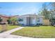 Charming single-story home with lush green lawn, new landscaping, and freshly painted exterior at 5050 Emerson S Ave, St Petersburg, FL 33707