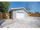 Spacious detached garage with a paved driveway, surrounded by a new privacy fence and gravel landscaping at 5050 Emerson S Ave, St Petersburg, FL 33707