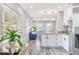 Open-concept kitchen with view into living room, featuring stainless steel appliances and granite countertops at 5050 Emerson S Ave, St Petersburg, FL 33707