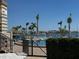 Beautiful community pool with palm trees and comfortable lounge chairs by the water with bay views at 5108 Brittany S Dr # 903, St Petersburg, FL 33715