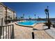 Spacious community pool surrounded by a paved deck, palm trees, and lush landscaping, perfect for relaxation at 5108 Brittany S Dr # 903, St Petersburg, FL 33715