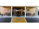 Building entrance featuring automatic doors, pillars, benches, and decorative accents at 5108 Brittany S Dr # 903, St Petersburg, FL 33715