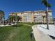 Beautifully landscaped exterior with lush green lawn and winding pathway around a large condominium complex at 5108 Brittany S Dr # 903, St Petersburg, FL 33715
