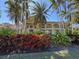 Stunning two-story home featuring lush landscaping, a balcony, and a charming exterior design at 5108 Brittany S Dr # 903, St Petersburg, FL 33715