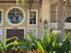 Inviting front entrance with well-manicured landscaping, large round window, and elegant double doors at 5108 Brittany S Dr # 903, St Petersburg, FL 33715