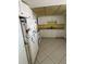 Outdated kitchen with yellow walls, white cabinets and appliances at 5108 Brittany S Dr # 903, St Petersburg, FL 33715