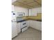 Kitchen with white appliances and cabinets at 5108 Brittany S Dr # 903, St Petersburg, FL 33715