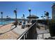 Community pool with lounge chairs and tiki hut overlooking the bay for relaxing and enjoying the views at 5108 Brittany S Dr # 903, St Petersburg, FL 33715