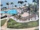 Scenic pool area overlooking the ocean surrounded by palm trees and white gravel at 5108 Brittany S Dr # 903, St Petersburg, FL 33715