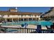 Exterior shot of a community pool and building, complete with lounge chairs and lush tropical landscaping at 5108 Brittany S Dr # 903, St Petersburg, FL 33715
