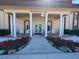 Welcoming Residents Club entrance with elegant columns, seating, and colorful landscaping at 5108 Brittany S Dr # 903, St Petersburg, FL 33715