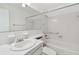 Clean white bathroom with a tub and shower features chrome fixtures at 6645 1St N Ave # 107, St Petersburg, FL 33710