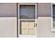 Close up of the cream front door featuring a security screen and sidelight at 6645 1St N Ave # 107, St Petersburg, FL 33710