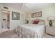 Bedroom with ensuite bathroom access, neutral walls, and a comfortable bed at 708 Tamiami S Trl # 112, Venice, FL 34285