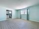 Bright, spacious bedroom with wood-look tile floors and an en-suite bathroom at 7960 2Nd N St, St Petersburg, FL 33702