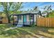 Cute single-story home with a small porch, tidy lawn, and wooden fence at 8308 N Mulberry St, Tampa, FL 33604