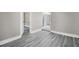 Hallway showcasing gray wood floors and neutral paint, leading to other rooms at 8308 N Mulberry St, Tampa, FL 33604
